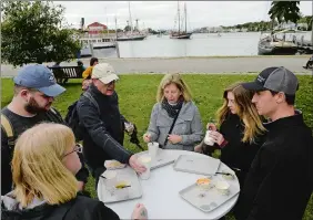  ?? DANA JENSEN/THE DAY ?? Clockwise from left, Lisa and James Contacos of Windsor Locks; Barry, Nancy and Betsy Gonder of Wellesley, Mass.; and Sam Voss of Manhattan, N.Y., chow down Saturday during the Chowder Days at the Mystic Seaport Museum.