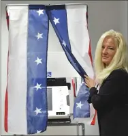  ?? BILL UHRICH — MEDIANEWS GROUP ?? Deborah Olivieri, Berks County director of elections, displays the new curtains that will provide privacy with the new voting machines.