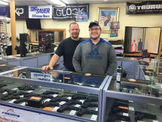  ??  ?? Joel Fulton and his son, Dave, minding a counter at Freedom Firearms (David Usborne)