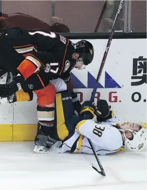  ?? HARRY HOW / GETTY IMAGES ?? Anaheim Ducks agitator Ryan Kesler, shown bowling over Viktor Arvidsson of the Predators during Game 2 of the Western Conference final on Sunday, has already become the object of Nashville’s scorn.