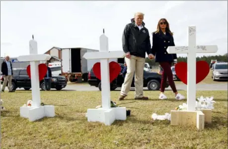  ?? CAROLYN KASTER — THE ASSOCIATED PRESS ?? President Donald Trump and first lady Melania Trump visit crosses at Providence Baptist Church in Smiths Station, Ala., Friday as they travel to tour areas where tornados killed 23 people in Lee County, Ala.