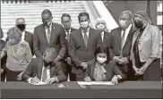  ?? AP-Jeff Amy ?? Georgia Gov. Brian Kemp, left, and Centers for Medicare and Medicaid Services Administra­tor Seema Verma sign health care waivers at the state Capitol in Atlanta, on Oct. 15.