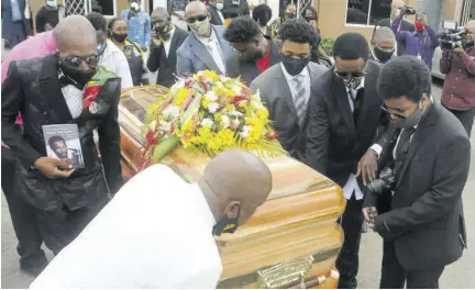  ??  ?? Pall-bearers removing the casket bearing the remains of Frederick “Toots” Hibbert after the funeral service at Perry’s Funeral Home in St Catherine yesterday.