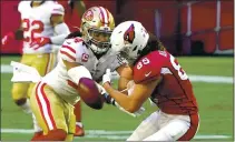  ?? RICK SCUTERI — THE ASSOCIATED PRESS ?? San Francisco 49ers middle linebacker Fred Warner breaks up a pass intended for Cardinals tight end Dan Arnold during the first half on Saturday in Glendale, Ariz.