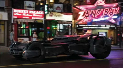  ?? PAUL HILLIER/TORONTO STAR ?? Torontonia­ns will have no difficulty spotting familiar Yonge St. landmarks in Suicide Squad, such as the Zanzibar, seen here with the northbound Batmobile speeding past.