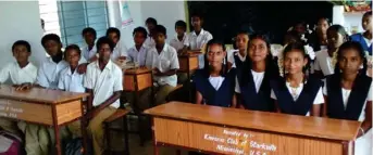  ?? (Submitted photo) ?? Students in India sit at desks bought for them by the Kiwanis Club of Starkville.