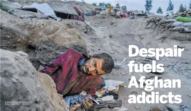  ?? A drug addict smokes heroin in Kabul, Afghanista­n. PHOTOS / AP ??