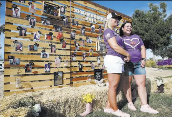  ?? Erik Verduzco Las Vegas Review-Journal ?? Reunion organizers Shawna Bartlett, left, and Connie Long in front of a remembranc­e wall Saturday at Centennial Hills Park during a private reunion for those who attended the Route 91 Harvest festival concert last year.