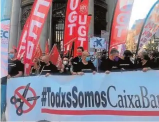  ?? EFE ?? Los sindicatos protestaro­n ayer ante la sede de Caixabank en Valencia