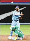  ??  ?? Toronto Blue Jays’ Marcus Semien, (top), throws to first base to complete a double play on a ball hit by Oakland Athletics’ Yan Gomes after forcing out Tony Kemp, (bottom), at second base in the seventh inning of a baseball game in Toronto, on Sept. 3. (AP)