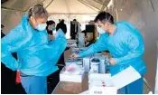  ?? PTI ?? Medical workers prepare for the opening of a COVID-19 testing facility in Camden, NJ, Wednesday