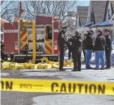  ?? HERALD PHOTO BY KEITH VIGLIONE ?? ON THE SCENE: First responders confer yesterday outside the fire scene on Merrifield Avenue in Watertown.