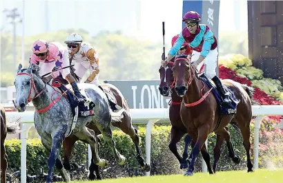  ?? Picture: HKJC ?? “MAGIC” DOUBLE. Joao Moreira, right, claims his second Group 1 of the day – the Longines Hong Kong Sprint – on Beat The Clock yesterday.