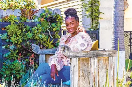  ?? ?? Williams sits in her garden filled with succulents of every size. The plants are her specialty in home and business landscape designs.