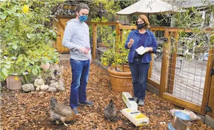  ?? TERRY CHEA AP PHOTOS ?? Ben Duddleston discusses buying chickens and supplies from Leslie Citroen, owner of Mill Valley Chickens in Mill Valley.