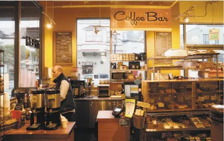  ?? Photos by Michael Macor / The Chronicle ?? Owner Richard Tarlov works the coffee bar at Canyon Market in San Francisco’s Glen Park. The owners have a long business relationsh­ip with Four Barrel and say blameless employees would be harmed if they drop the company.