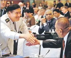  ??  ?? China’s Joint Staff Department Deputy Chief Admiral Sun Jianguo shakes hands with delegates at the IISS Shangri-La Dialogue in Singapore. — Reuters photo