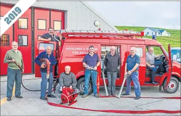  ??  ?? Firefighte­rs recreate the picture 33 years later, on the van’s return to Whalsay, with Peter Hewson, left, standing in for David Arthur, and Jim Smith, the vehicle’s owner, third right