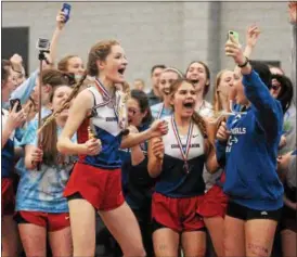  ?? MARY ALBL — REGISTER ?? Members of the Coginchaug indoor track & field team celebrate after winning the Shoreline Conference title on Saturday at the Floyd Little Athletic Center.