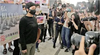  ?? — AFP photo ?? Choy (left) arrives at the West Kowloon Courts building in Hong Kong.