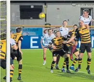  ??  ?? Lee Ashcroft rises highest to head Dundee’s opening goal at Alloa on Friday
