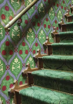  ??  ?? ABOVE Oak stairs with a custom carpet runner replaced unfinished studs covered in industrial carpeting. Decorative moulding on either side was the clever solution to cover a ½” gap between treads and walls.