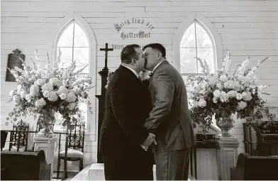  ?? Photos by Marie D. De Jesús / Staff photograph­er ?? Tennis Luke Gobert, left, kisses Rafael Franco after their wedding at St. John’s Church at Sam Houston Park on Sunday. The Heritage Society hosted 30 consecutiv­e express weddings in the building over Valentine’s Day weekend.