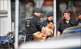  ?? ALEXANDER KOERNER / GETTY IMAGES ?? Authoritie­s carry evidence Sunday from the house of a man in Muenster, Germany, who police say drove a van at high speed Saturday into a crowd outside a pub, killing two before committing suicide with a gun.
