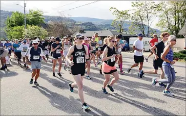  ?? VLADO ZAMECNIK/Special to the Herald ?? Athletes stride along during the Peach City Half Marathon and 10K held Sunday morning in Penticton.