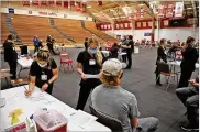  ?? BILL LACKEY / STAFF ?? A COVID vaccinatio­n clinic is set up in the Pam Evans Smith Arena at Wittenberg University to vaccinate the Wittenberg students Thursday.