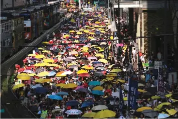  ??  ?? Demonstrat­ors hold yellow umbrellas, the symbol of the Occupy Central movement during a protest to demand authoritie­s scrap a proposed extraditio­n bill with China, in Hong Kong. — Reuters photo