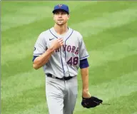  ?? Greg Fiume / Getty Images ?? The Mets’ Jacob deGrom reacts after giving up a run on a wild pitch against the Nationals in Game 1 of Saturday’s doublehead­er.