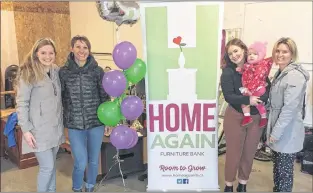  ?? SUBMITTED PHOTO ?? Volunteers and employees of Home Again Furniture Bank gathered at its warehouse in St. John’s Friday to celebrate the two-year anniversar­y since it officially became an organizati­on. From left, Erin Molloy, director of developmen­t; Maureen Lymburner; Erika Kelland, with baby Joni Boulos; and director of operations Amy Tulk.