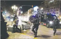  ?? AP PHOTO ?? Catalan Mossos d’Esquadra regional police officers take position during a protest over the detention of deposed leader of Catalonia’s pro-independen­ce party Carles Puigdemont in Barcelona, Spain, Sunday. Puigdemont was arrested Sunday by German police...