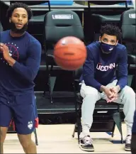  ?? David Butler II / Associated Press ?? UConn’s James Bouknight, middle, looks on from the sideline as his teammates warm up before Tuesday’s game against Butler.