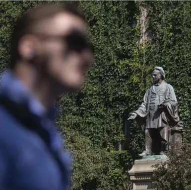  ?? CHRIS YOUNG/THE CANADIAN PRESS FILE PHOTO ?? A pedestrian walks past a statue of 19th-century educator Egerton Ryerson at Toronto’s Ryerson University.