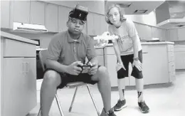  ?? MIKE STOCKER/STAFF FILE PHOTO ?? Alexander De Jesus and Adam Solymosi, both 12, practiced flying drones in class at Apollo Middle School’s aeronautic­al sciences magnet program.