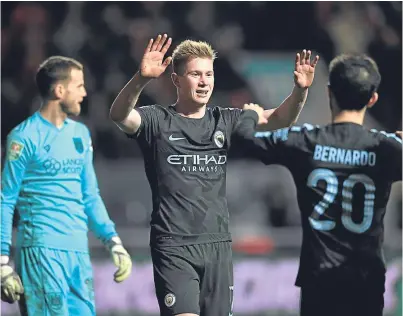  ?? Picture: Getty Images. ?? Kevin De Bruyne celebrates with Bernardo Silva after finally killing off Bristol City’s hopes with the visitors’ third goal on the night.