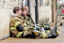  ??  ?? Firefighte­rs take a break during the hours-long battle to extinguish Saturday’s fire.