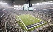  ??  ?? In this Sept. 8, 2013, file photo, fans watch at the start of an NFL football game between the New York Giants and Dallas Cowboys, in Arlington, Texas. The Cowboys are worth $4.2 billion, making them the most valuable sports franchise for the second...