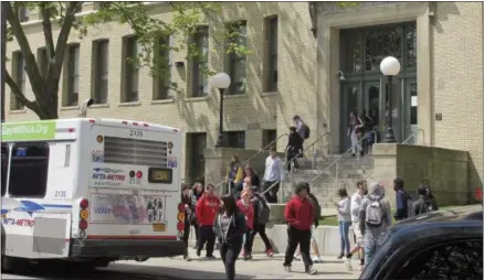  ?? CAROLYN THOMPSON — THE ASSOCIATED PRESS ?? In this May 10photo, students leave South Park High School in Buffalo, N.Y. The Medicaid changes being advanced as part of the health overhaul are sounding familiar alarms for school districts still getting their financial footing after the Great...