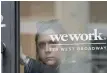  ?? — Reuters ?? A woman exits a Wework co-working space in New York.