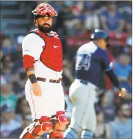  ?? Michael Dwyer / Associated Press ?? Boston Red Sox’s Sandy Leon stands at home plate after Tampa Bay Rays’ Avisail Garcia (24) scored on a single by Yandy Diaz during the ninth inning of the first game of a doublehead­er in Boston on Saturday.