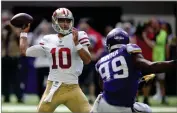  ?? AP PHOTO BY JIM MONE ?? In this Sunday, Sept. 9, 2018, file photo, San Francisco 49ers quarterbac­k Jimmy Garoppolo throws a pass over Minnesota Vikings defensive end Danielle Hunter (99) during the second half of an NFL football game, in Minneapoli­s.