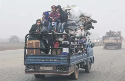  ?? AP ?? Civilians ride in a truck as they flee Maarat al-Numan in Syria before a government offensive yesterday.