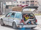  ?? ?? Children sit in the back of a vehicle arriving at the Daraj quarter of Gaza City. Picture: AFP