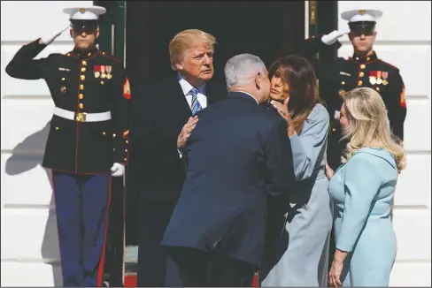  ?? The Associated Press ?? PRESIDENTI­AL GREETING: President Donald Trump and first lady Melania Trump greet Israeli Prime Minister Benjamin Netanyahu and his wife Sara Netanyahu at the White House, Monday, in Washington.