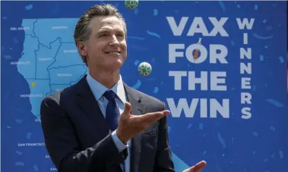  ?? Photograph: Jay L Clendenin/Los Angeles Times/REX/Shuttersto­ck ?? California’s governor, Gavin Newsom, celebrates the end of pandemic-era restrictio­ns by drawing 10 lucky winners to receive $1.5m each.