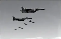  ?? SOUTH KOREA DEFENSE MINISTRY VIA AP ?? IN THIS PHOTO PROVIDED BY SOUTH KOREA Defense Ministry, South Korean F-15 fighter jets drop bombs over the Korean Peninsula, South Korea, on Thursday. The United States flew some of its most advanced warplanes in bombing drills with ally South Korea on...