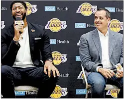  ?? AP/DAMIAN DOVARGANES ?? ABOVE Los Angeles Lakers Coach Frank Vogel (right) introduces Anthony Davis at a news conference Saturday at the UCLA Health Training Center in El Segundo, Calif. RIGHT LeBron James (left) and Davis share a moment after Davis was introduced.
